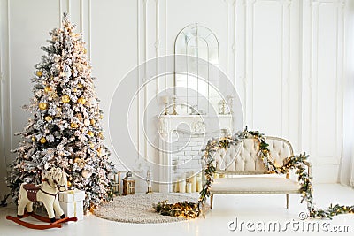 Stylish Christmas light interior with a soft armchair or sofa decorated with garland Stock Photo