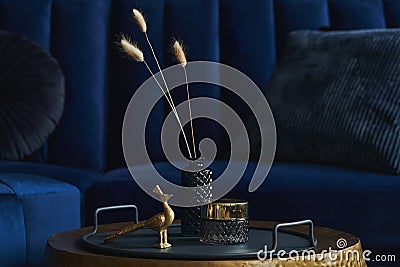 Stylish close up on the elegant details in the glamour living room interior. Golden peacock and creative personal accessories. Stock Photo