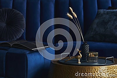 Stylish close up on the elegant details in the glamour living room interior. Golden peacock and creative personal accessories. Stock Photo