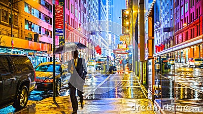 Stylish colorful wet New York NYC commuter with umbrella Stock Photo