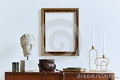 Stylish composition of artist workspace room with design retro teak commode, mock up poster frame, book, decoration and elegant. Stock Photo