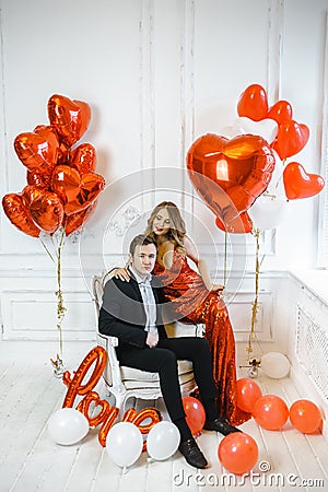 Stylish couple man and woman with balloons for Valentine`s day Stock Photo