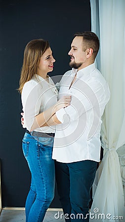 Stylish couple-man and woman in white shirts and jeans hugging. photo in bright colors Stock Photo