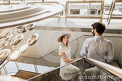 Stylish couple on stairs in restaurant Stock Photo