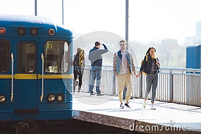 stylish couple of tourists going at outdoor subway Stock Photo