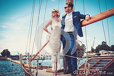 http://thumbs.dreamstime.com/x/stylish-couple-yacht-wealthy-luxury-57163731.jpg