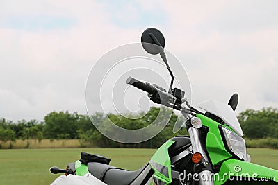 Stylish cross motorcycle on green grass outdoors Stock Photo