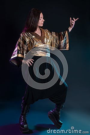 Stylish and daring image, futuristic fashion. A young woman in a multicultural outfit Stock Photo