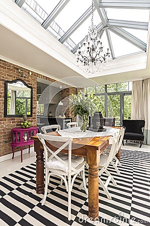 Stylish dining room with a glass roof Stock Photo