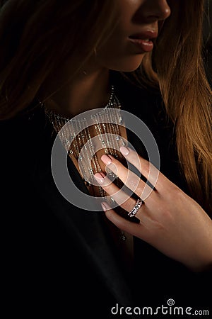 Stylish elegant necklace on the black photo background. Expensive pendant with a diamond on her neck. Fashion blogger Stock Photo