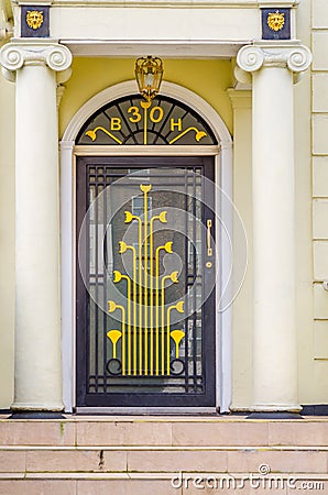 Stylish entrance to the building with distinctive gold decoratio Stock Photo