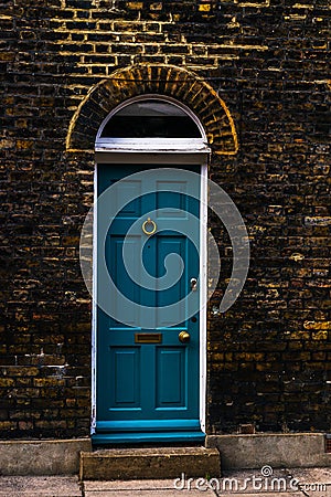 stylish entrance to a residential building, an interesting facade of the old brick arches above the door, a typical old English b Stock Photo
