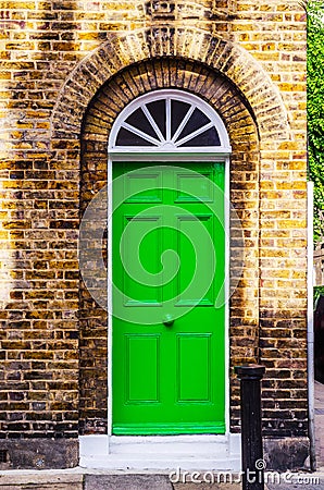 stylish entrance to a residential building, an interesting facade of the old brick arches above the door, a typical old English b Stock Photo