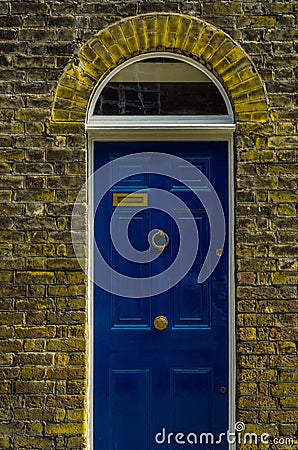 stylish entrance to a residential building, an interesting facade of the old brick arches above the door, a typical old English b Stock Photo