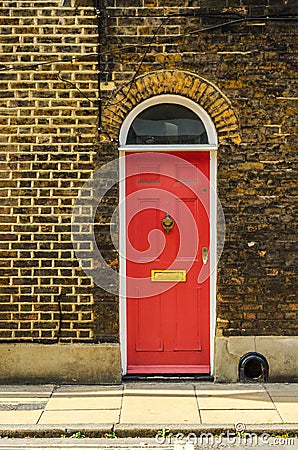 stylish entrance to a residential building, an interesting facade of the old brick arches above the door, a typical old English b Stock Photo