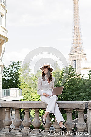 Stylish freelancer holding laptop on urban Stock Photo