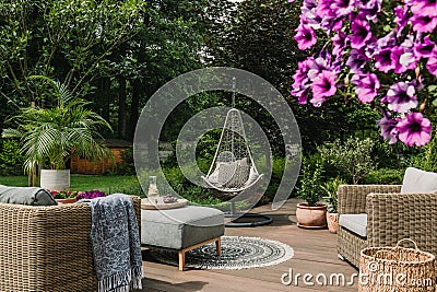 Stylish garden decoration with fancy egg chair and garden furniture Stock Photo