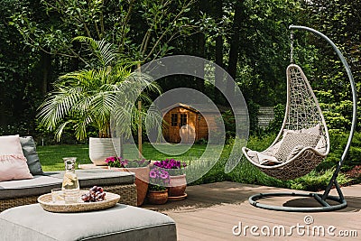 Stylish garden decoration with fancy egg chair and garden furniture Stock Photo