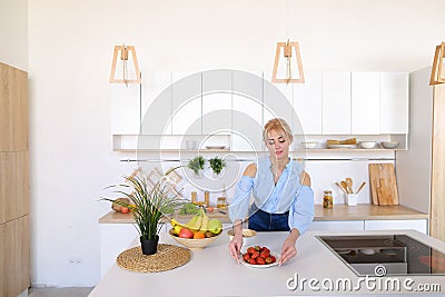 Stylish girl cooks posing for breakfast in morning, standing at Stock Photo