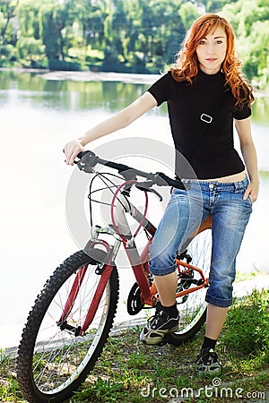 Stylish girl outdoors with her bicycle Stock Photo