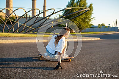 Stylish girl in white stockings ride on longboard Editorial Stock Photo