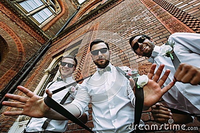 Stylish groomsmen in the sunglasses and bow-ties Stock Photo