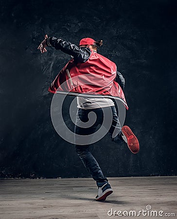 Stylish guy performs breakdance acrobatic elements. Stock Photo