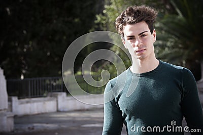 Stylish hair young man outdoors, tight knit intense light Stock Photo