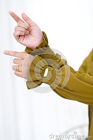 Stylish Hand Gesture and Sleeves Showing The Beautiful Asian Hijab Woman Hand Stock Photo