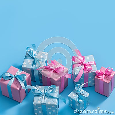 Stylish handmade gift boxes decorated with ribbons and bows. Gifts in pink and blue packaging. Stock Photo
