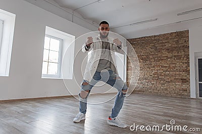 Stylish handsome young dancer in a jacket and ripped jeans Stock Photo