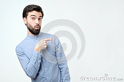 Stylish handsome young hispanic man pointing aside. Stock Photo