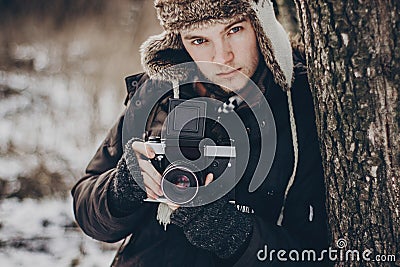 Stylish hipster traveler man with old photo camera exploring in Stock Photo