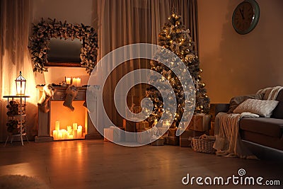 Stylish interior with decorative fireplace and beautiful Christmas tree Stock Photo