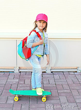 Stylish little girl child riding skateboard Stock Photo