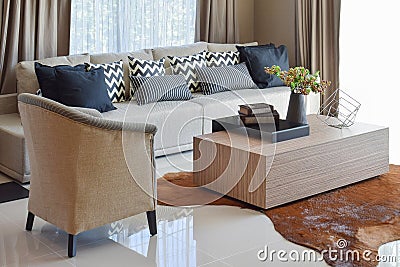 Stylish living room with grey striped pillows on sofa Stock Photo