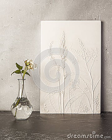 Stylish living room interior with botanical bas-relief wildflowers for wall artand flowers in vase. 3D Flower plaster decor. Stock Photo