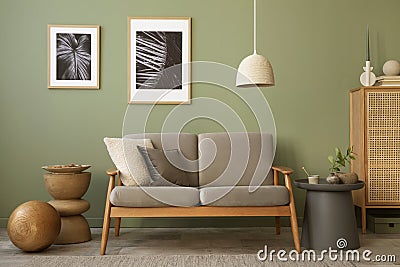 Stylish living room interior composition. Modern scandi sofa, mock up frames, wooden commode and creative personal accessories. Stock Photo