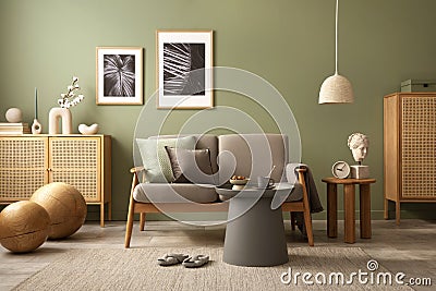 Stylish living room interior composition. Modern scandi sofa, mock up frames, wooden commode and creative personal accessories. Stock Photo