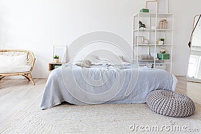 Stylish loft bedroom interior. Spacious design apartment with light walls large windows big bed. Clean modern decoration with Stock Photo