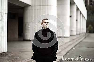 Stylish man in black trenchcoat Stock Photo