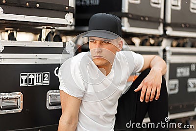 Stylish model man in a black cap and white T-shirt Stock Photo