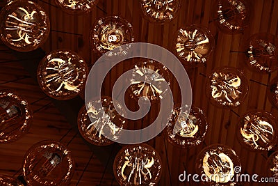 Stylish, modern and decorative lamps of Edison of round shape in the rows. Light bulbs in retro style. A lot celling Stock Photo