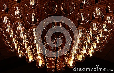 Stylish, modern and decorative lamps of Edison of round shape in the rows. Light bulbs in retro style. A lot celling Stock Photo