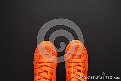 Stylish orange sneakers on dark background Stock Photo