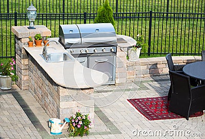 Stylish outdoor kitchen on a brick patio Stock Photo