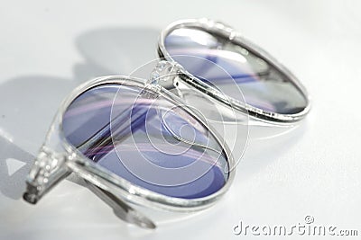 Stylish pair of eye glasses on a white background. Concept of a correct optics against ametropia. Spectacles with chameleon and Stock Photo