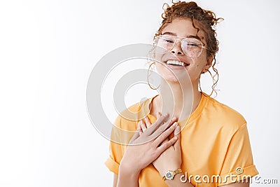 Stylish popular outgoing carefree charming young teenage girl redhead freckled press hands chest delighted smiling Stock Photo