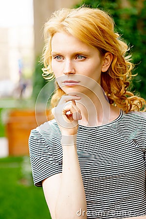 Stylish portrait of young caucasian girl with curly blond hair Stock Photo