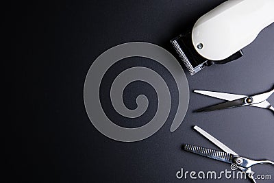 Stylish Professional Barber Scissors and White electric clippers Stock Photo